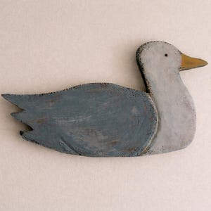 May include: A set of three ceramic mugs with a speckled, matte finish. The mugs are in shades of cream, light gray, and dark gray. Each mug has a simple, minimalist design and a rounded handle.