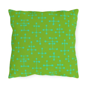 May include: Green throw pillow with a repeating pattern of turquoise blue abstract shapes.