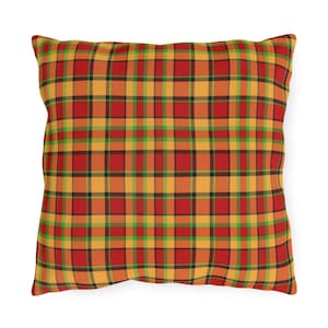May include: A red, orange, and green plaid throw pillow with a square shape.
