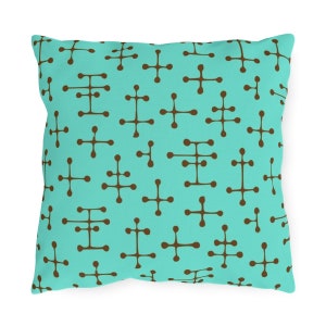 May include: A turquoise blue throw pillow with a brown geometric pattern. The pattern is made up of small circles connected by lines.