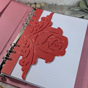 May include: A set of three ceramic mugs with a speckled, cream-colored glaze. Each mug features a different hand-painted floral design in shades of blue, green, and yellow. The mugs have a simple, rounded shape.