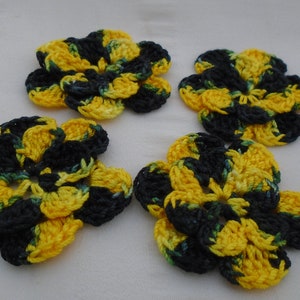 May include: Four crocheted flowers in black, yellow, and green. The flowers are made with a combination of single crochet and double crochet stitches.