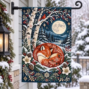 May include: A rectangular garden flag featuring a sleeping fox curled in a circle, surrounded by white birch trees, pine cones, red berries, and white flowers against a dark blue winter night sky with a full moon and a red cardinal bird.