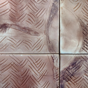 May include: Four square ceramic tiles with a brown and white chevron pattern. The tiles are arranged in a grid pattern.