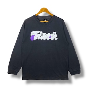 May include: Black long-sleeve shirt with the word "Fable!" in white, stylized lettering. The design includes a purple tongue sticking out from the letter "F". The shirt is hanging on a wooden hanger.