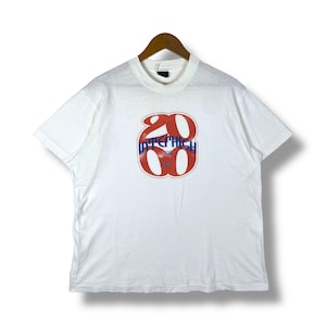 May include: White short-sleeved t-shirt with a red and blue graphic of the number 2000 with the word "INTERHIGH" printed inside the number.