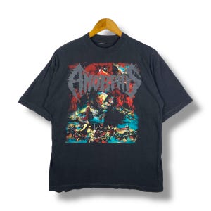 May include: Black t-shirt with a graphic print of a band called "Amorphis". The graphic is a colorful illustration of a scene with a red, orange, and yellow background.