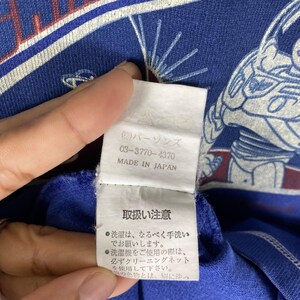 May include: A white tag with black text that reads "(株)パーソンズ 03-3770-4370 MADE IN JAPAN" and a white tag with black text that reads "取扱い注意 ●洗濯は、なるべく手洗い でお願いします。 ●洗濯機をご使用の際は、 必ずクリーニングネット を使用して下さい。 色物とは、別に洗っ &sigma;".