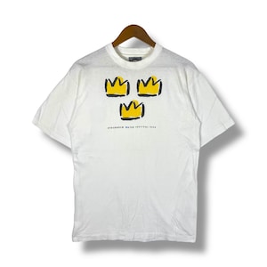 May include: White t-shirt with a graphic of three yellow crowns and the text "STOCKHOLM WATER FESTIVAL 1994".