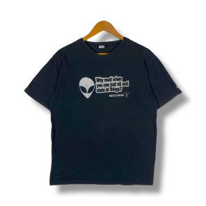 May include: Black t-shirt with a silver alien graphic and the text "Why read when you can just sit and stare at things?"  BESCHWA.