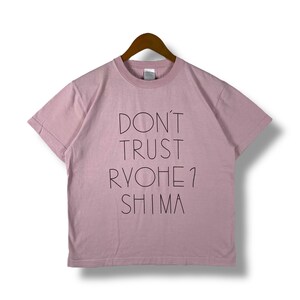 May include: A pink t-shirt with the text "DON'T TRUST RYOOHE? SHIMA" printed in black.