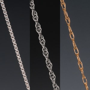 May include: Three different types of silver chains, one is a box chain, one is a rope chain, and one is a cable chain.