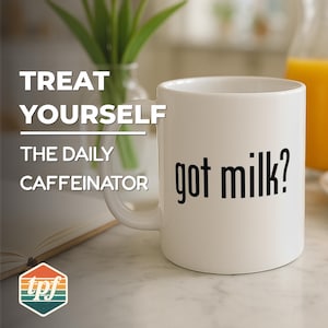 May include: White ceramic mug with the phrase "got milk?" in black lettering. The mug is part of a set with the text "TREAT YOURSELF THE DAILY CAFFEINATOR". The mug is on a marble surface.