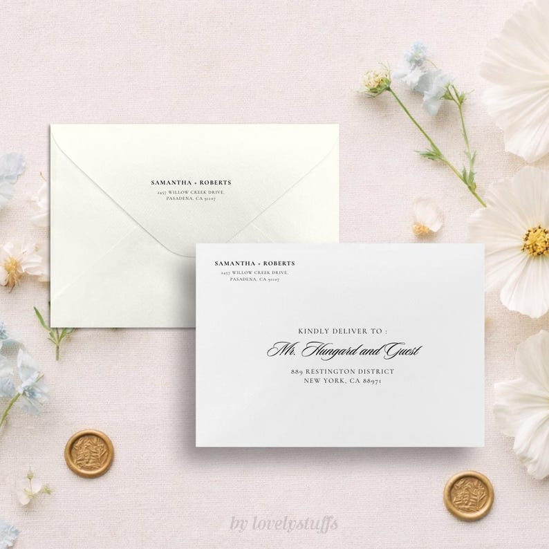 May include: Ivory wedding invitation envelopes with elegant script. One envelope is sealed, and the other is open, displaying the recipient's address. The text reads "Samantha + Roberts" and "Kindly Deliver To: Mr. Hangard and Guest". Gold wax seals and floral accents complete the design.