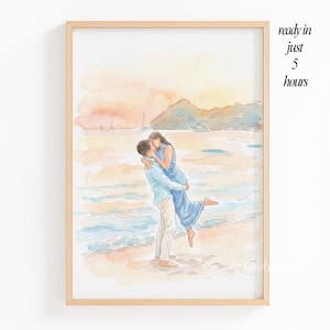 May include: Watercolor print of a couple embracing on a beach at sunset. The man is holding the woman in his arms. The artwork is framed in a light wood frame. Text on the right says "ready in just 5 hours".