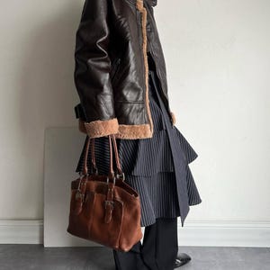 women's aviator bomber, shearling leather jacket, distressed brown coat, fur lined bomber, B3 pilot jacket, real lambskin coat, vintage trench bomber, WWII style flight coat, warm winter shearling, cozy fur collar coat, brown leather jacket, women's bomber outerwear, flight style trench, sheepskin winter coat, aviator lambskin bomber, leather outerwear women, retro shearling bomber, lambskin winter jacket, women's vintage coat, warm leather jacket, RAF style bomber, handmade aviator coat