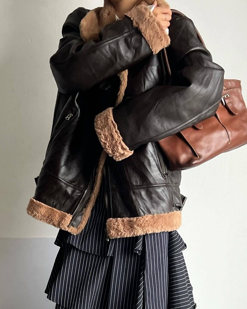 classic aviator bomber, women's RAF trench coat, warm lambskin bomber, WWII leather jacket, sheepskin pilot coat, vintage bomber style, retro fur coat women, distressed lambskin trench, handmade sheepskin bomber, leather winter coat, brown flight jacket, real shearling coat women, winter fur collar bomber, pilot-style leather jacket, thick lambskin coat, warm fur trench coat, stylish leather bomber, elegant shearling coat, vintage flight trench, WWII inspired bomber, cozy lambskin outerwear