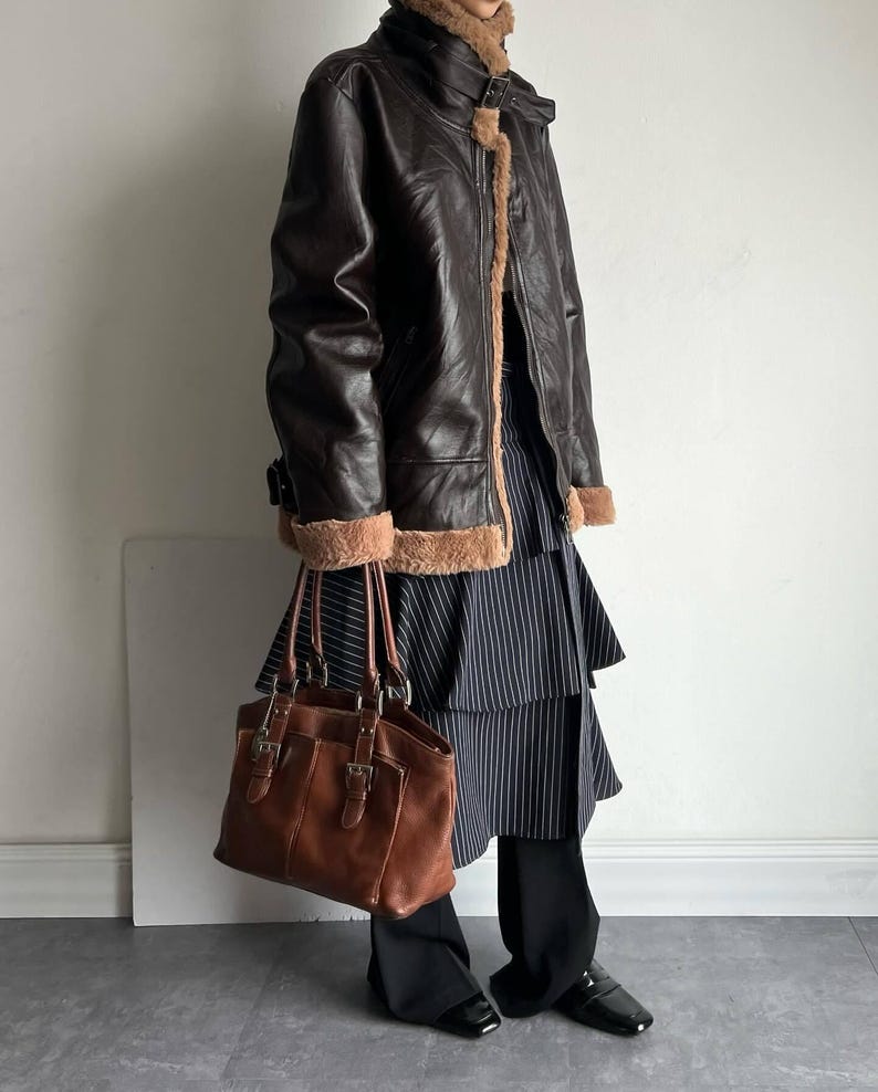 vintage shearling coat, B3 bomber leather, brown lambskin jacket, women's RAF bomber, distressed leather coat, fur collar trench, winter flight coat, warm sheepskin jacket, real leather bomber, retro style outerwear, pilot trench coat, WWII aviator jacket, classic flight bomber, women's winter coat, cozy fur bomber, real lambskin flight coat, handmade leather bomber, brown shearling jacket, soft fur collar jacket, heavy duty trench coat, luxury shearling bomber, heritage RAF trench coat