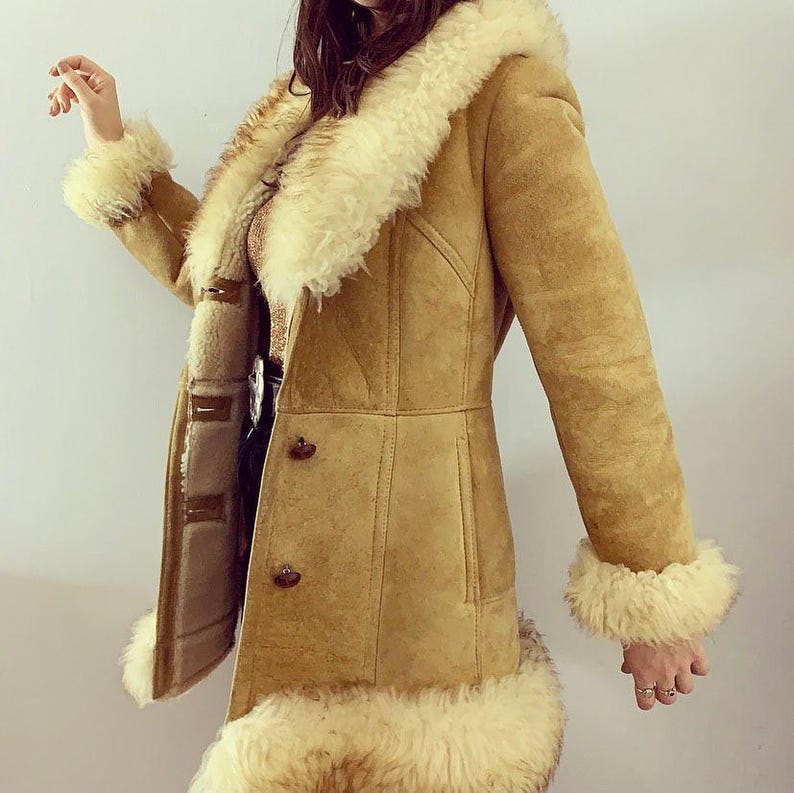 women’s vintage fur coat, handmade shearling coat, warm Afghan suede overcoat, Penny Lane mid-length coat, boho-style winter jacket, retro 90s shearling coat, classic suede fur-trimmed coat, timeless fashion overcoat, soft and cozy winter wear, stylish mid-length coat for women, Afghan leather fur coat, premium suede and shearling coat, elegant hippie winter coat, warm and fashionable overcoat, women's classic winter outerwear, luxury handmade suede coat, statement fur overcoat