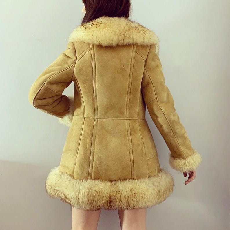 brown Penny Lane coat, vintage suede overcoat, women's mid-length fur coat, shearling boho jacket, handmade Afghan leather coat, warm winter outerwear, 90s inspired shearling coat, classic hippie style coat, cozy suede trench, bohemian winter fashion, stylish vintage coat for women, fur-trimmed Afghan overcoat, soft suede mid-length coat, elegant warm coat for winter, timeless handmade coat, luxurious shearling coat, unique boho-style outerwear, retro-inspired winter coat