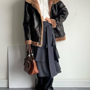 RAF bomber jacket, vintage women's flight coat, leather shearling outerwear, WWII aviator trench, warm brown lambskin coat, real sheepskin bomber, women's fur collar jacket, distressed flight bomber, cozy winter coat, handmade leather bomber, classic B3 aviator jacket, brown shearling flight coat, lambskin leather trench, fur cuff winter jacket, retro trench coat women, luxury winter outerwear, pilot bomber jacket, vintage lambskin bomber, elegant fur lined coat, women's heavy shearling coat