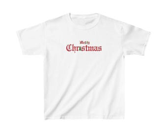 May include: White t-shirt with a red "Merry Christmas" graphic in a vintage font.