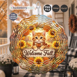 May include: A circular metal wind spinner featuring a ginger kitten wearing a plaid scarf, resting paws on a wooden sign that reads Welcome Fall. The design is surrounded by sunflowers and autumn foliage, with a hanging loop at the top.