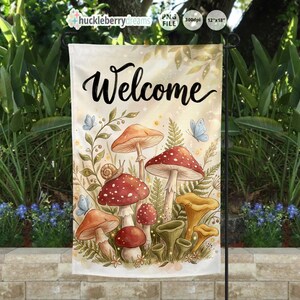 May include: A garden flag with the word "Welcome" in black script. The flag features a watercolor illustration of mushrooms, ferns, a snail, and butterflies in shades of red, orange, yellow, and green. The flag measures 12" x 18".