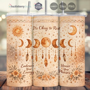 May include: A 20oz tumbler with a celestial design. The tumbler features a sun, moon phases, feathers, and floral accents in shades of brown and beige. Text includes "It's Okay to Rest", "Embrace Your Energy", and "Honor Your Phases".