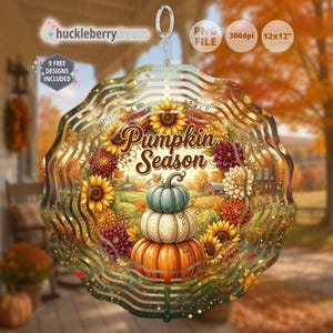 May include: A circular metal wind spinner featuring a stack of three pumpkins in blue, white, and orange, surrounded by a wreath of sunflowers and dahlias. The text Pumpkin Season is printed in brown script. It includes a silver hanging ring at the top.