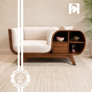 May include: A wooden armchair with a cream-colored upholstered seat and backrest. The frame extends into a side unit featuring an open shelf, a small drawer, and additional storage compartments containing a bowl, a shell, and an hourglass.