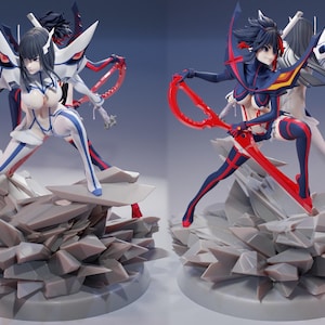 May include: Two anime figures, one in a white and blue outfit with a sword, the other in a red and black outfit with a red sword. Both figures are standing on a rocky base.