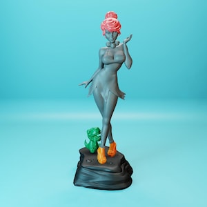 May include: A gray figurine of a woman with pink hair, wearing a gray dress and orange shoes. She is standing on a black rock base with a green dinosaur figurine beside her.