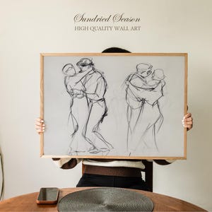 May include: A framed print of pencil sketches depicting couples dancing. The artwork is in a light wood frame and features the text "Sundried Season" and "HIGH QUALITY WALL ART" at the top.