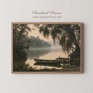 May include: A framed wall art print titled Sundried Season High Quality Wall Art featuring a landscape painting of a small wooden boat floating on a calm, misty lake at dawn, with weeping willow trees and a wooden dock along the shoreline.