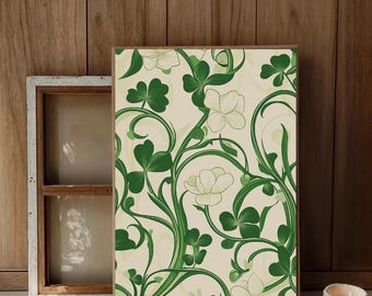 May include: A framed art print featuring a repeating pattern of green shamrocks and white flowers on a cream background. The artwork has a botanical theme and is set against a wooden backdrop.