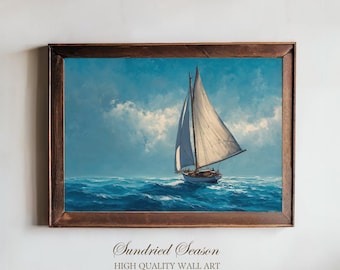 May include: A framed nautical painting depicts a sailboat with white sails on a blue ocean under a cloudy sky. The artwork is in a brown wooden frame. The text "Sundried Season HIGH QUALITY WALL ART" is at the bottom.