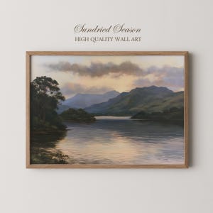 May include: A framed landscape painting titled Sundried Season High Quality Wall Art, depicting a calm lake surrounded by dark green trees and rolling mountains under a soft, golden-hued sunset sky with scattered clouds and gentle reflections.