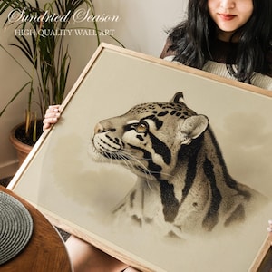 May include: A framed print of a clouded leopard illustration. The artwork depicts the animal's unique coat pattern in brown and black tones. The frame is made of light wood. The text "Sundried Season HIGH QUALITY WALL ART" is visible. A piece of wall art.