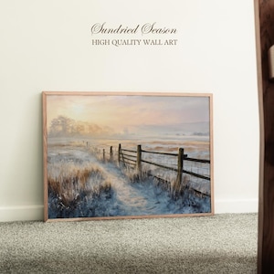May include: A framed landscape painting of a winter scene. The artwork shows a snow-covered field with a wooden fence and a path leading into the distance. The sky is a soft blend of pink and orange hues, with the text "Sundried Season" and "HIGH QUALITY WALL ART".