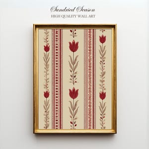 May include: A framed wall art print featuring a repeating floral pattern of red tulips and foliage on a cream background. The artwork is framed in a gold-colored frame. The text "Sundried Season HIGH QUALITY WALL ART" is at the top.