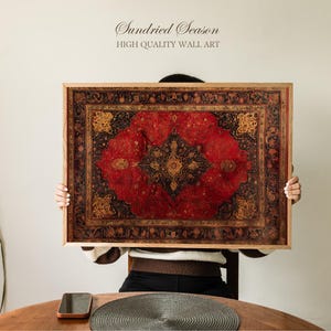 May include: A framed wall art piece featuring a detailed, ornate rug design in shades of red, black, and gold. The artwork is rectangular with a wooden frame. The text "Sundried Season HIGH QUALITY WALL ART" is at the top.