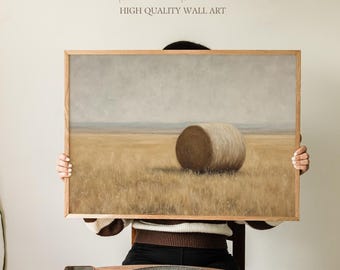 May include: A framed landscape print featuring a large hay bale in a field of dry grass under a cloudy sky. The artwork has a neutral color palette with the text "Sundried Season" and "HIGH QUALITY WALL ART" in the upper portion.