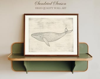 May include: A framed print of a whale illustration in grayscale, displayed on a green and tan shelf. The artwork features the text "Sundried Season" and "High Quality Wall Art". The whale is depicted swimming underwater, with fine detail.