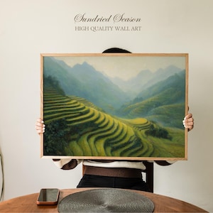 May include: A framed landscape art print depicting terraced rice fields and mountains. The artwork is in a wooden frame and has the text "Sundried Season HIGH QUALITY WALL ART" at the top. The colour palette includes shades of green, yellow, and blue.