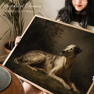 Pode incluir: Impressão artística emoldurada com uma pintura de um cão deitado na relva. O cão tem uma pelagem manchada e está emoldurado em madeira clara. O texto "Sundried Season High Quality Wall Art" é visível no canto superior esquerdo.