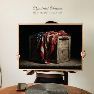 May include: A framed wall art print featuring a vintage still life. The artwork depicts a wooden chest draped with a weathered American flag. The print has a dark background and the text "Sundried Season HIGH QUALITY WALL ART" at the top.