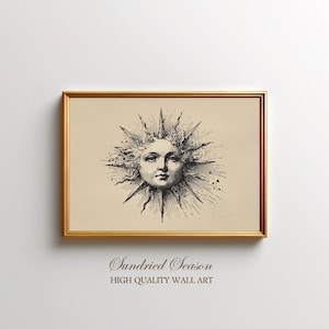 May include: Framed wall art featuring a detailed black and white illustration of a sun with a face, radiating outward. The artwork is set against a beige background and framed in a gold-colored frame. The text "Sundried Season HIGH QUALITY WALL ART" is at the bottom.