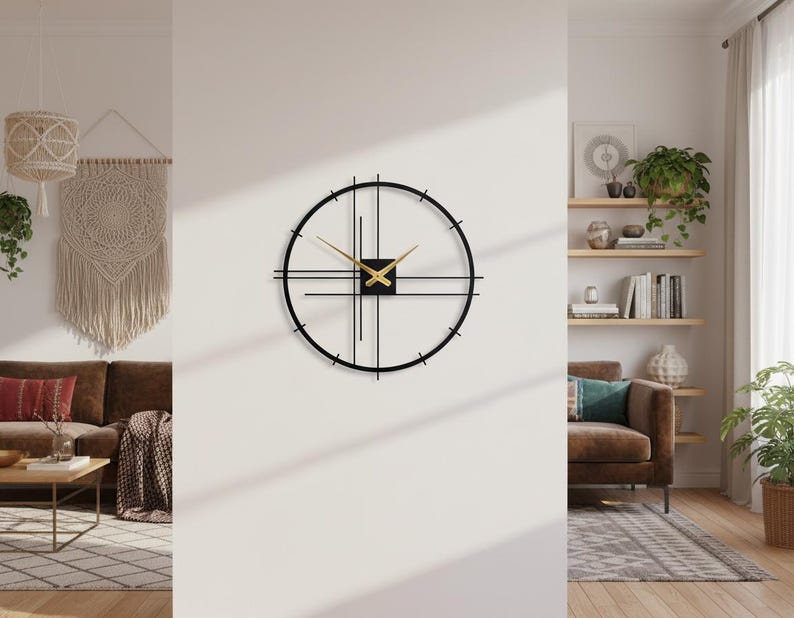 May include: A modern black and gold wall clock with a minimalist design. The clock features a circular frame with intersecting lines and gold hands. The clock is mounted on a white wall, adding a touch of contemporary style to the room.