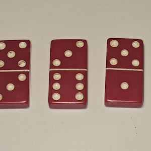 3 vintage red bakelite dominoes